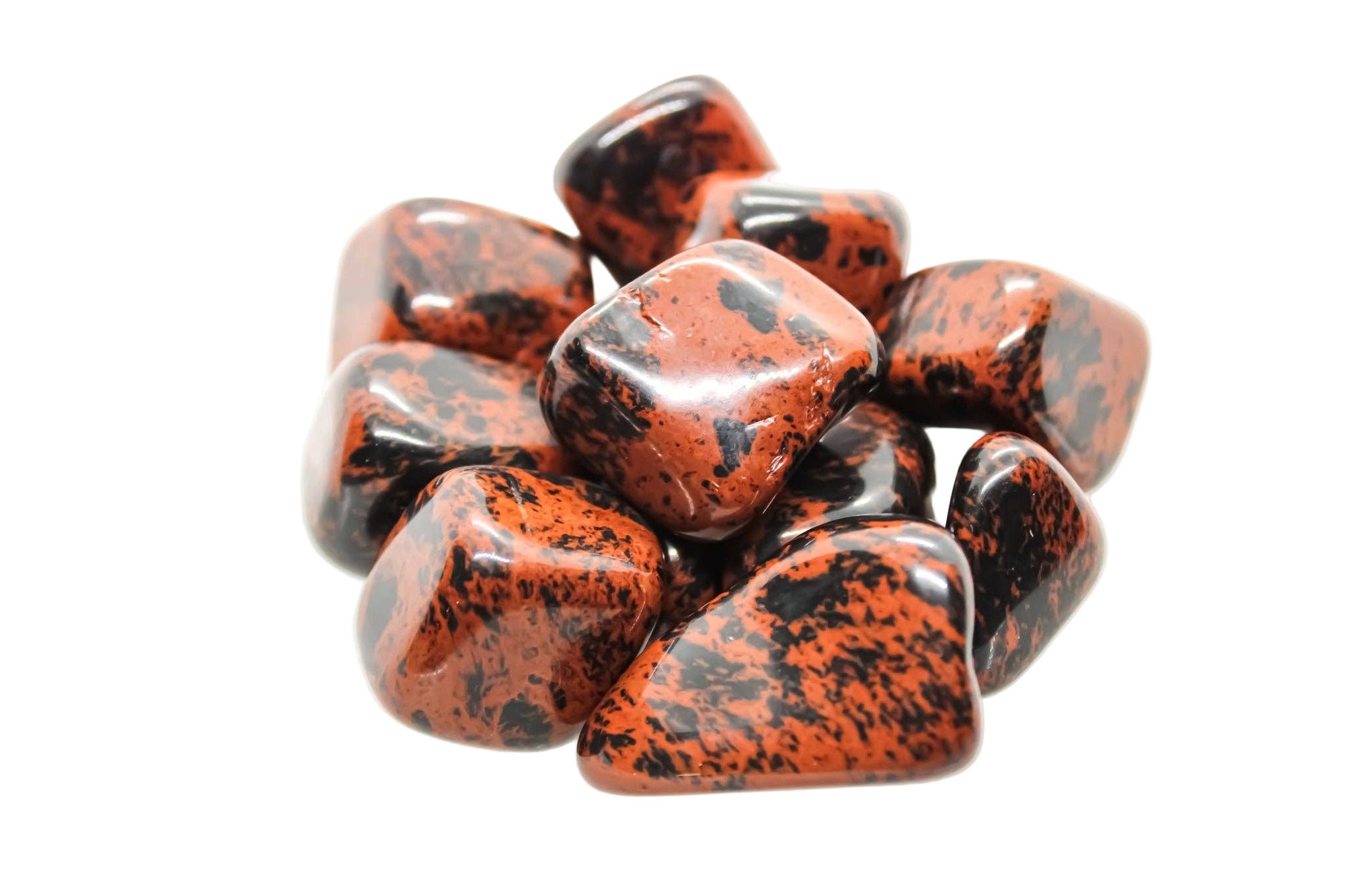 Red and black speckled stones on a white background