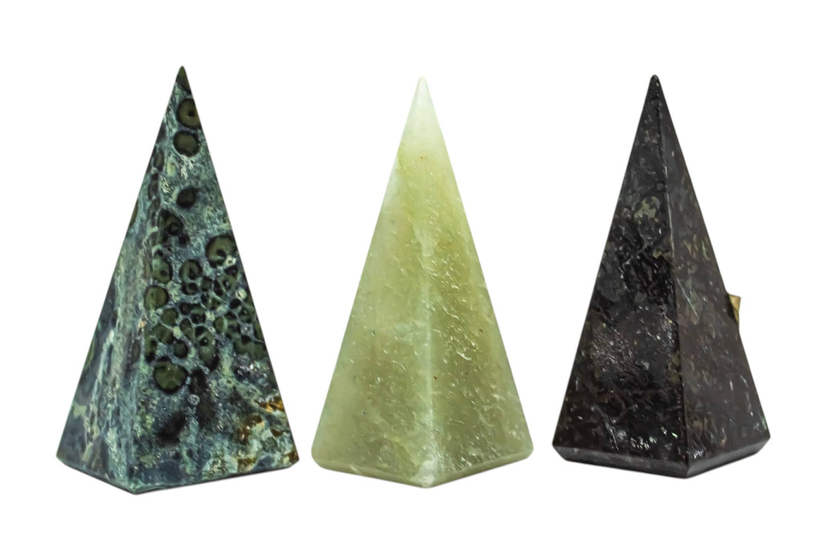 Three pyramid-shaped stones with different patterns on a white background